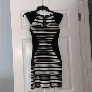 Black and white striped, form-fitting dress.